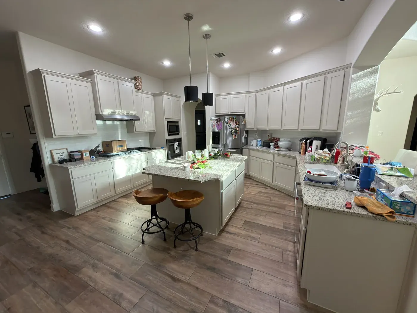 Kitchen cabinets after painting — bright white finish, crisp lines, clean job site by V&S Services Austin TX