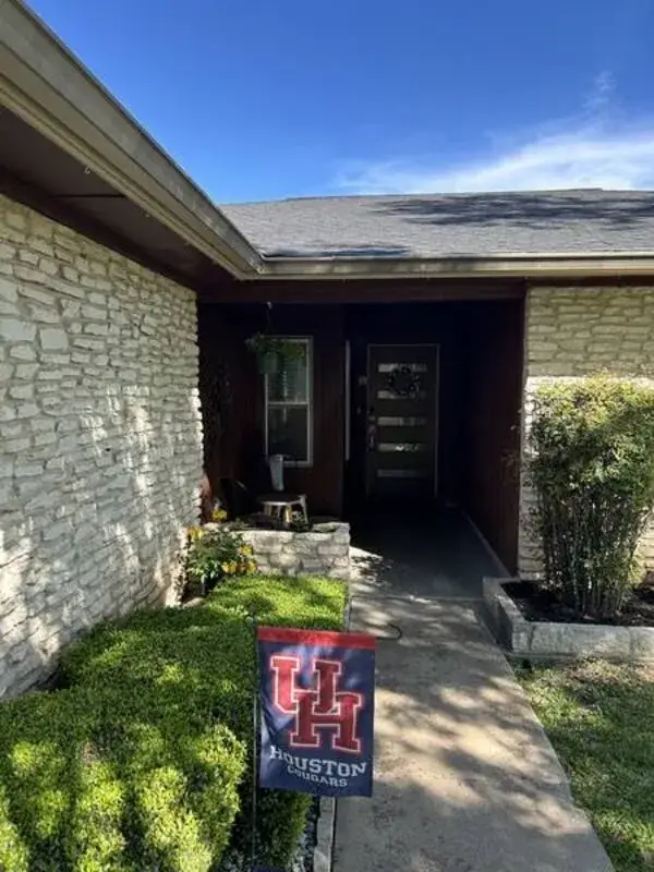 Home entryway before exterior painting — dated brown trim, Austin TX