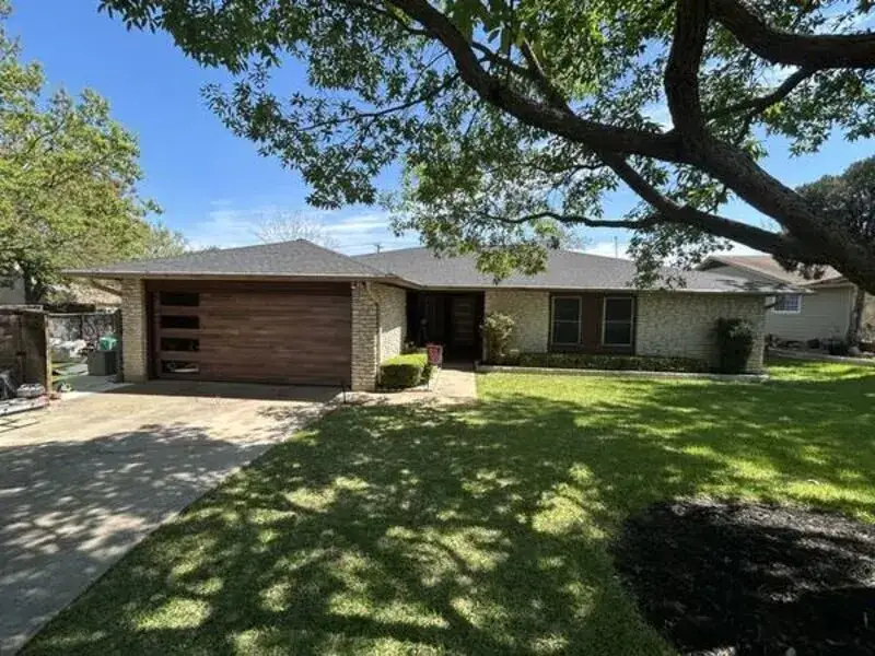 Full house exterior before painting — brown dated trim, Austin TX residential