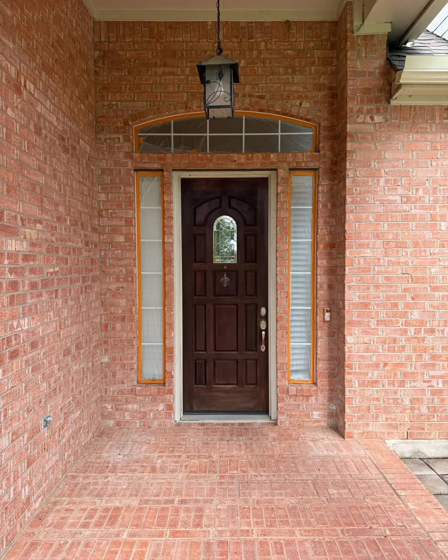 Before: Arched brick front entry painted bright white in Pflugerville, TX