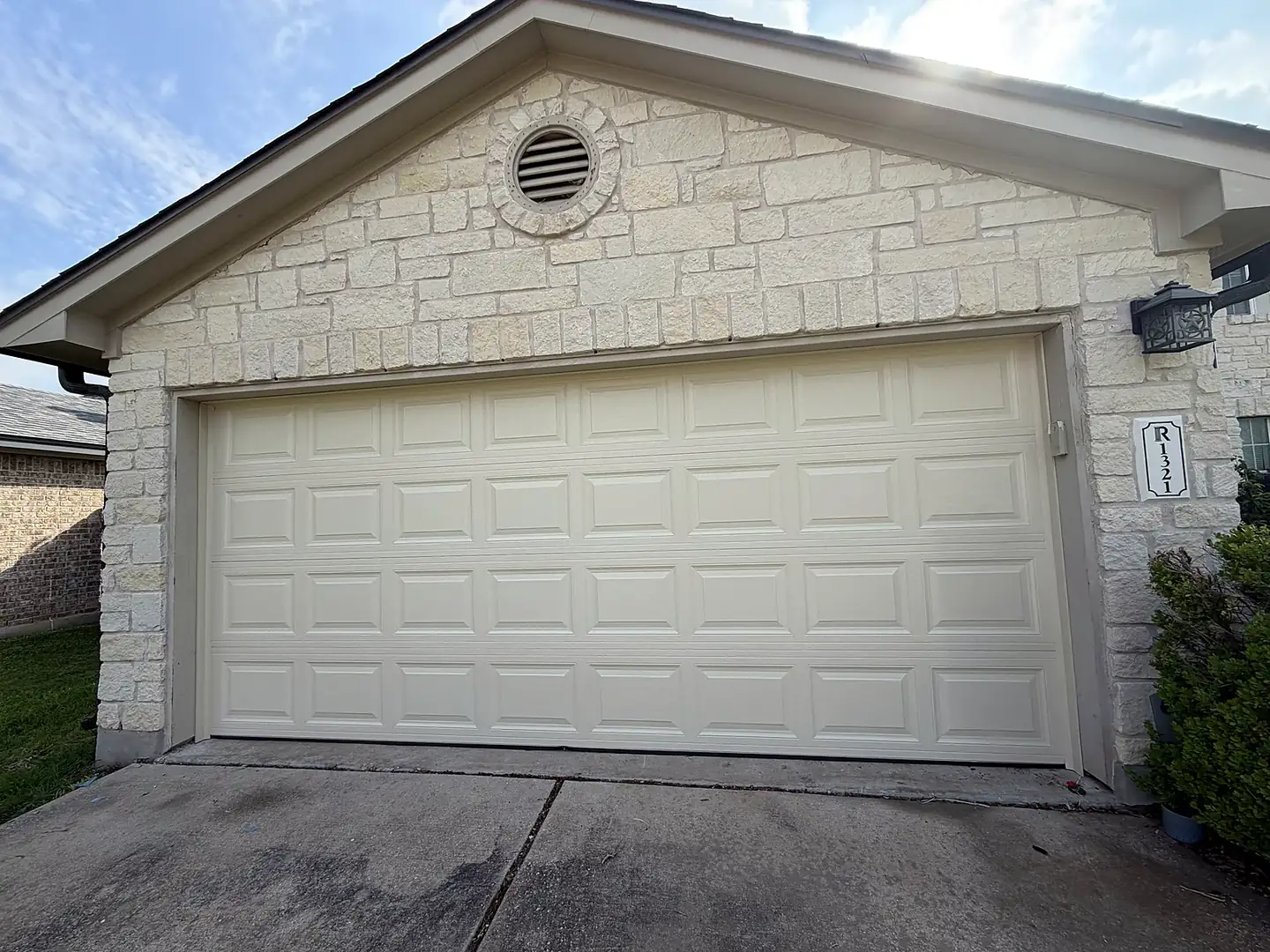 Before: Garage door refinished from cream to charcoal in Pflugerville, TX