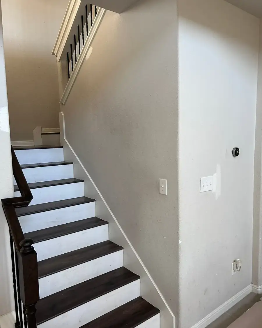 Before: Entry and stairwell walls, scuffed to fresh paint with crisp trim in Austin, TX