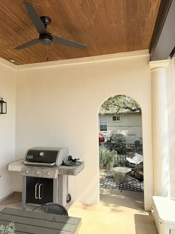Covered patio with freshly painted walls, column and stained wood ceiling in Pflugerville, TX