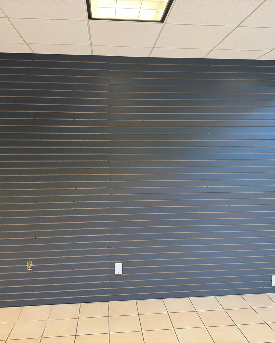 Commercial office lobby slat wall painted deep navy by V&S Painting & More