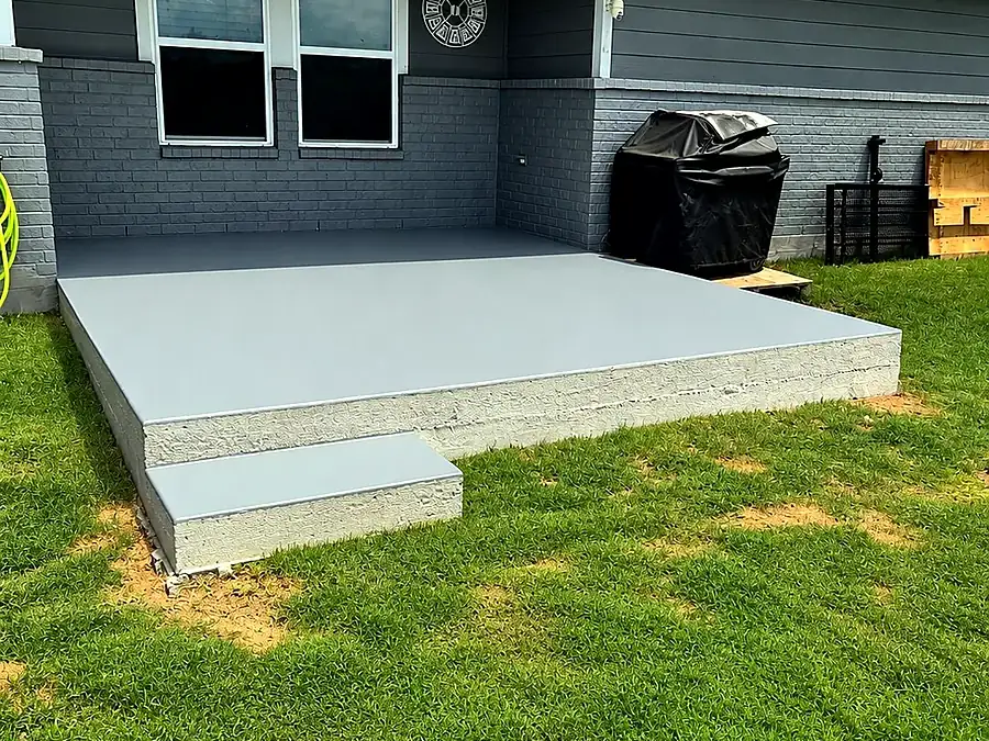 Concrete back patio cleaned and coated light gray