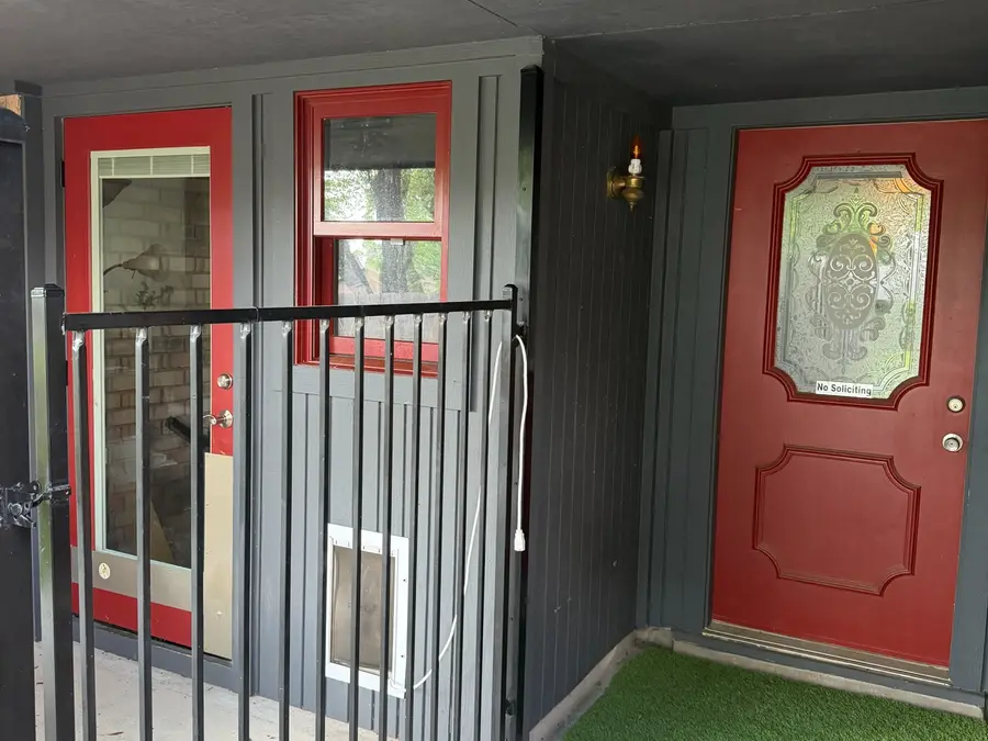 Front and side doors before refinishing, red on gray board and batten, Austin