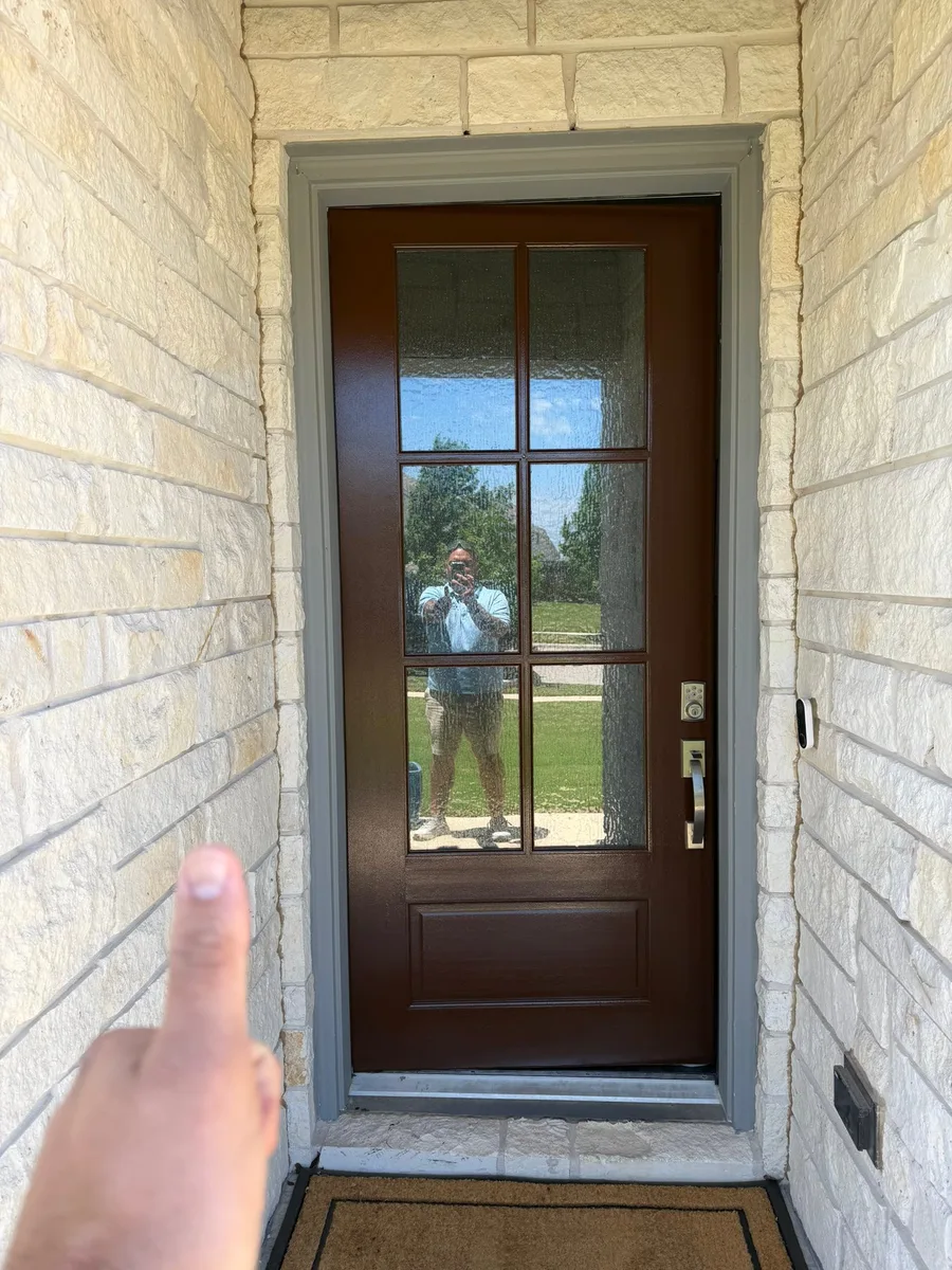 Same front door after refinishing, warm brown with crisp gray trim by V&S Painting in Austin