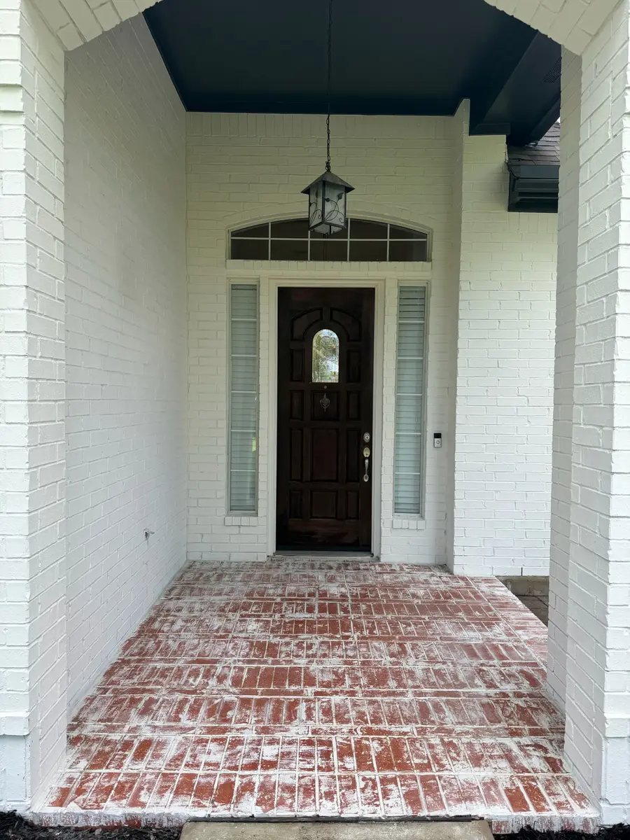Arched brick front entry painted bright white by V&S Painting, Austin