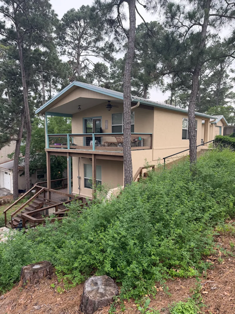 Hillside Austin area home exterior, tan with green trim, painted by V&S Services