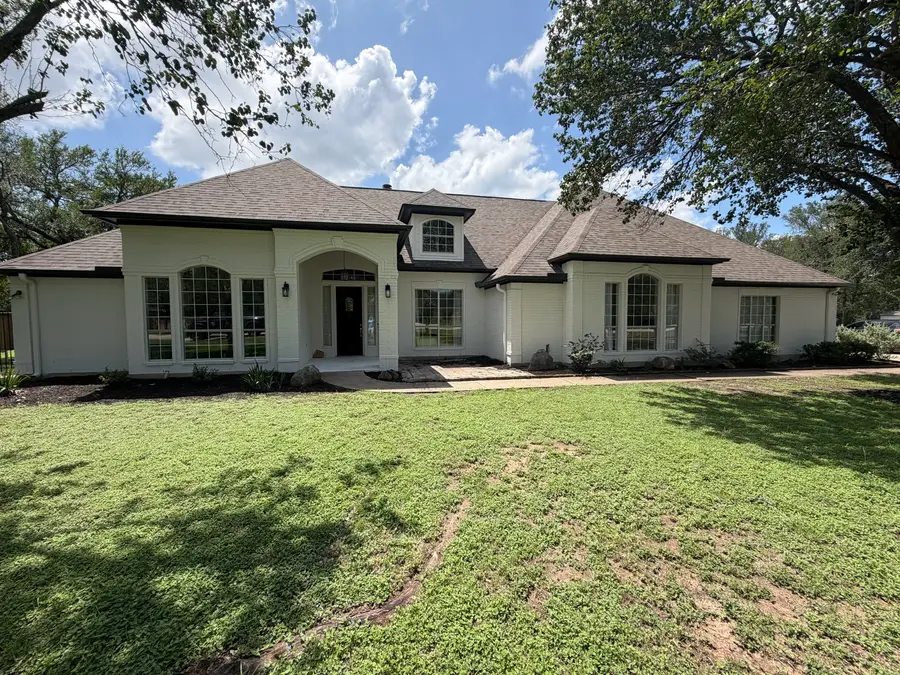 Austin ranch home painted bright white with black trim by V&S Painting