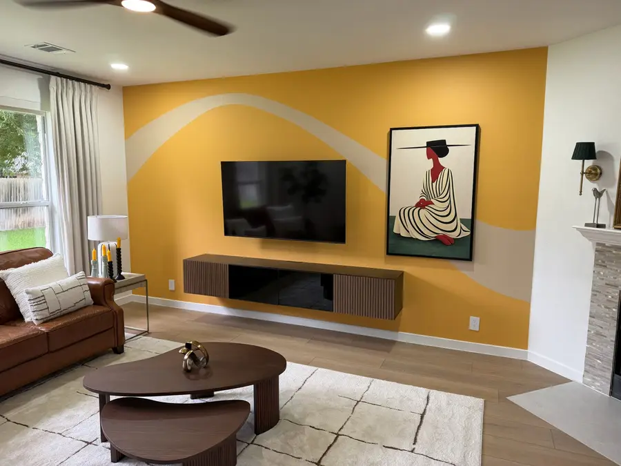Living room with a custom gold wave accent wall mural by V&S Painting, Austin