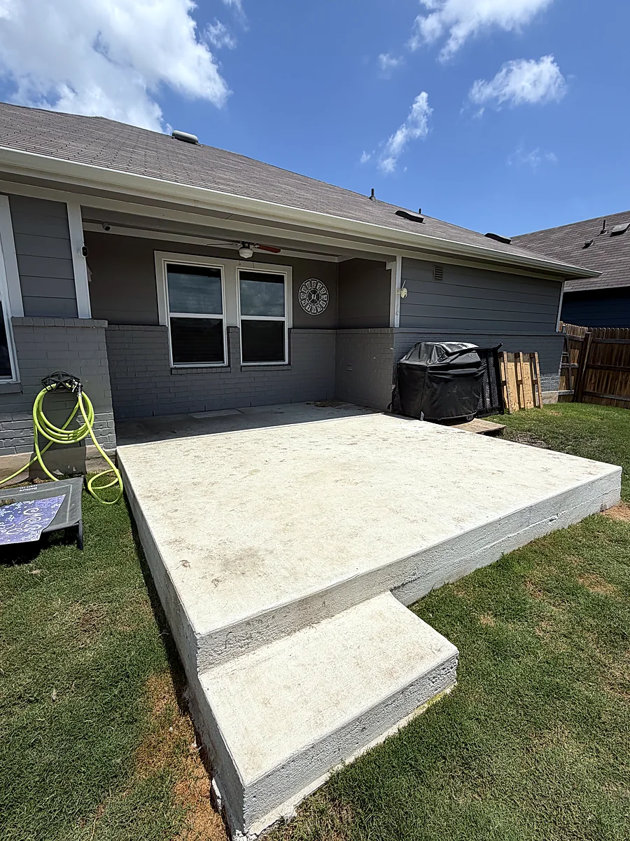 Bare stained concrete patio before coating, Austin