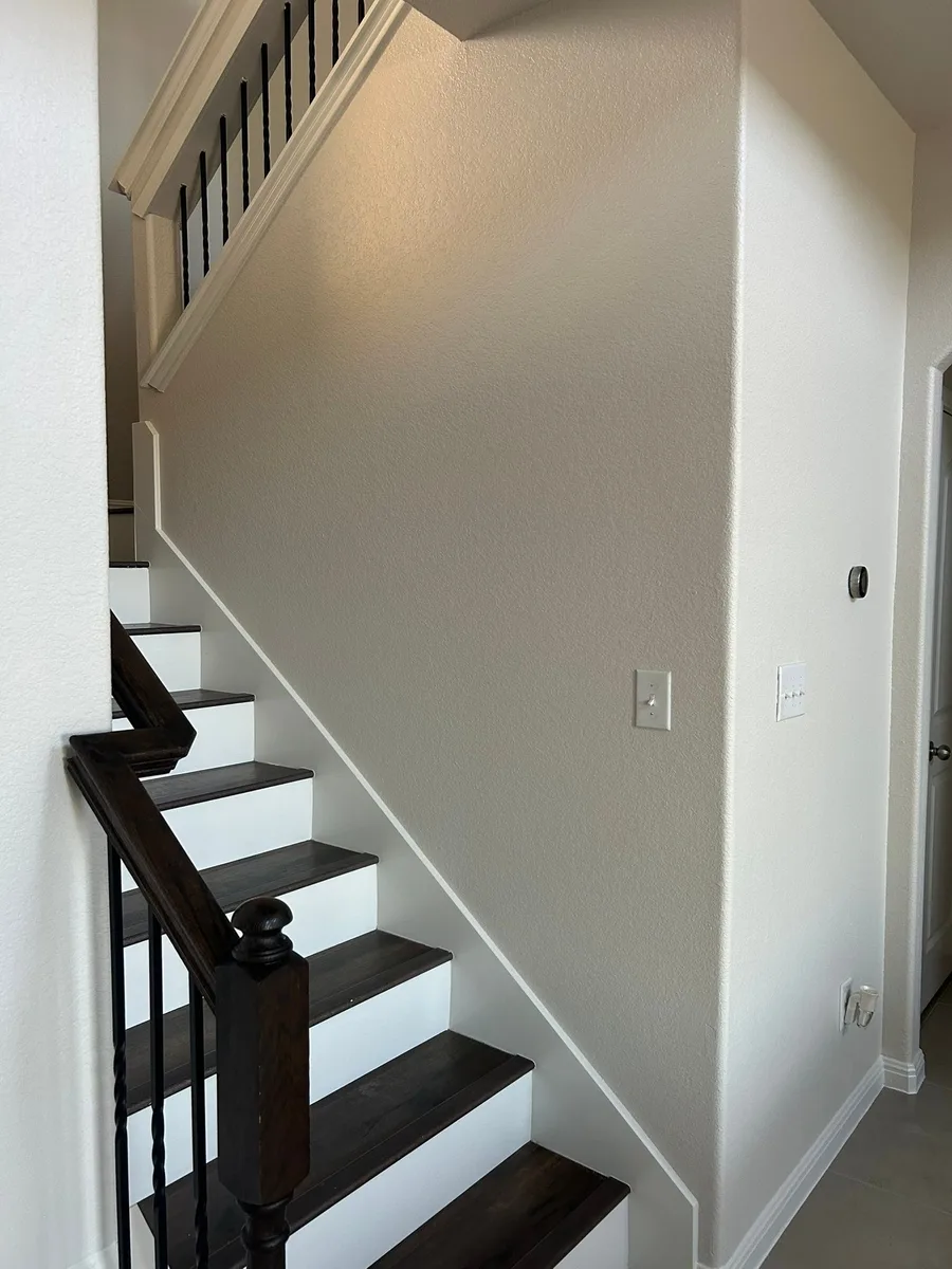 Entry and stairwell after painting, clean fresh paint with crisp trim by V&S Painting, Austin