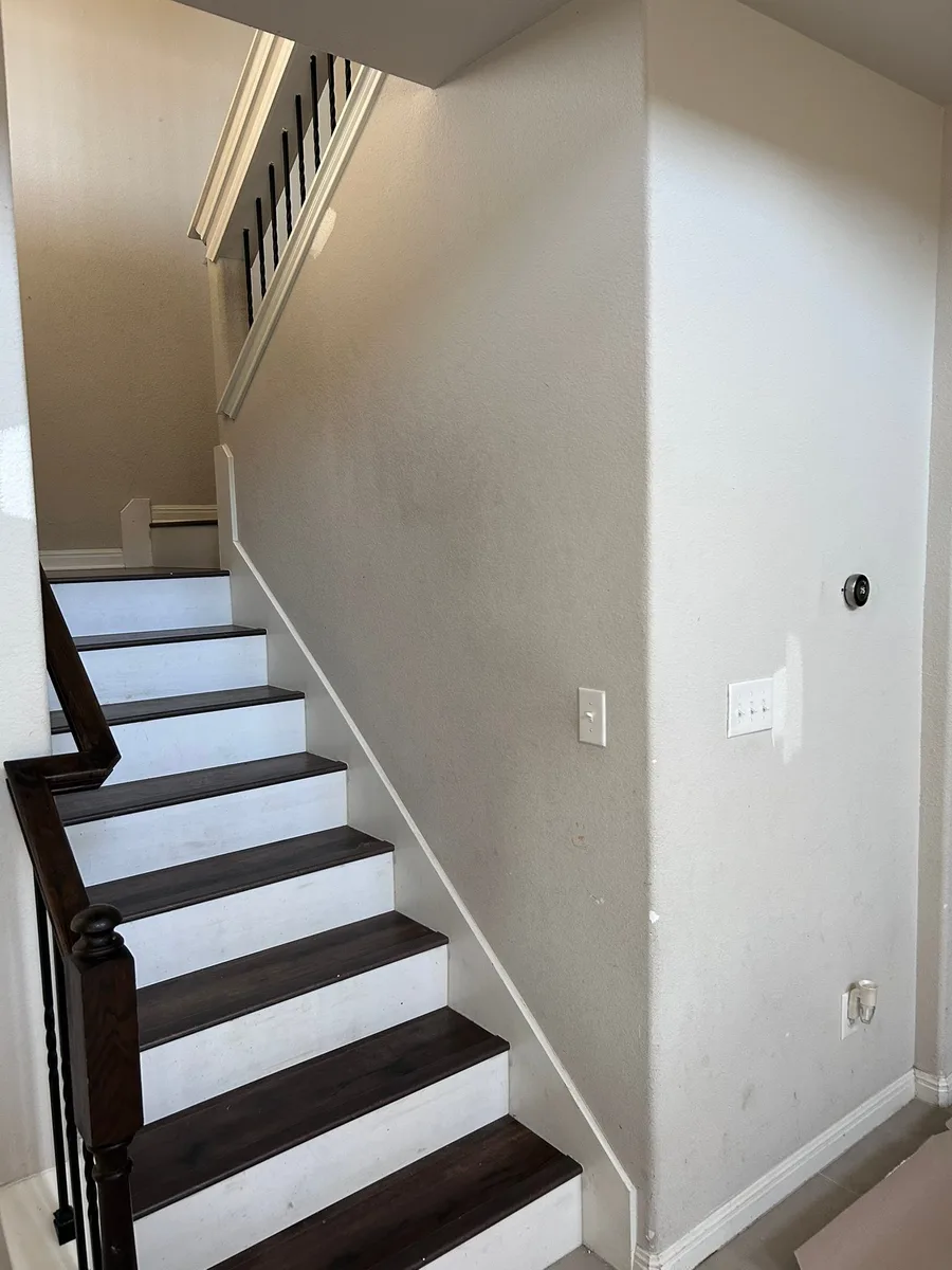 Entry and stairwell before painting, dingy and scuffed, Austin
