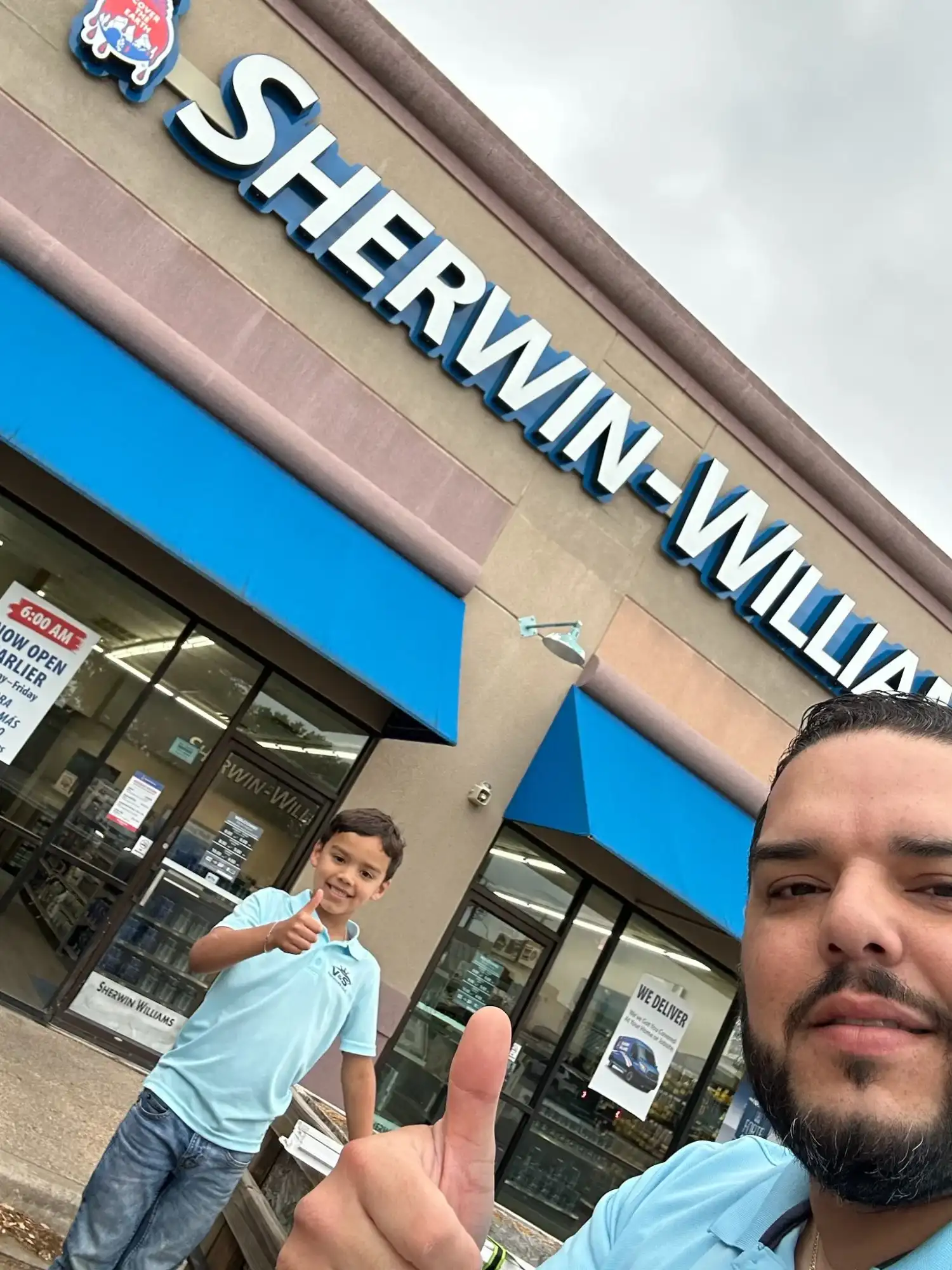 Julio Diaz and son Sebastian giving thumbs up outside Sherwin-Williams store, V&S Services Austin TX
