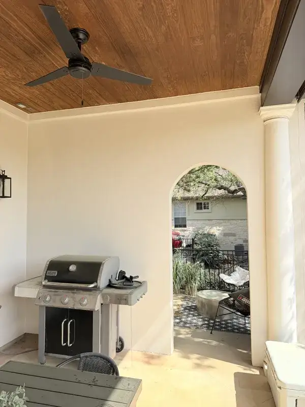 Same patio after painting — warm finish, wood plank ceiling by V&S Services Austin